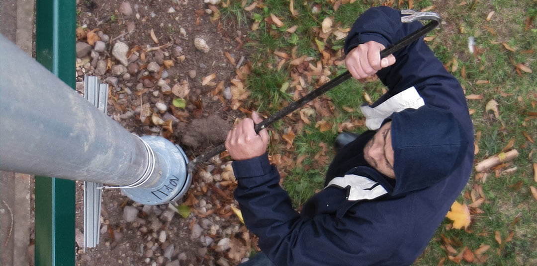 Man vandalising lamppost column